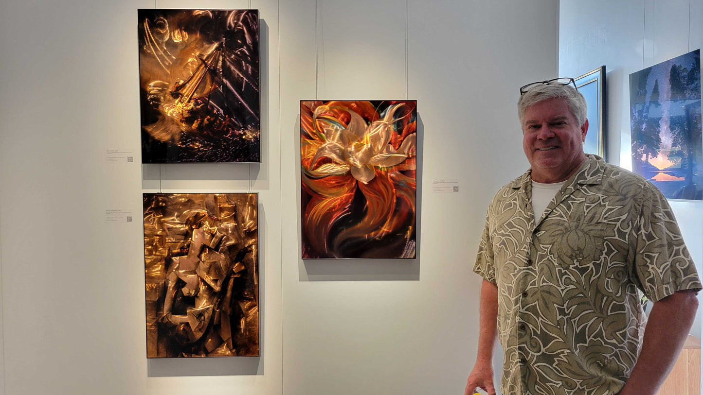 Man standing in front of abstract paintings on a wall