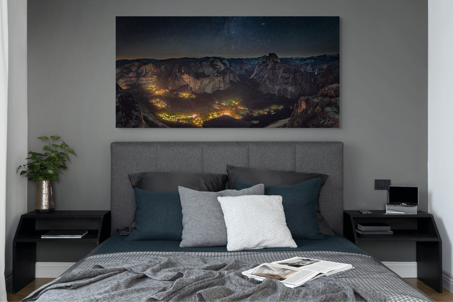 A wall art mockup featuring the photograph titled "Artificial Darkness" by landscape photographer J K Lovelace as a 60 inch wide metal print with inset frame on display in a modern bedroom.