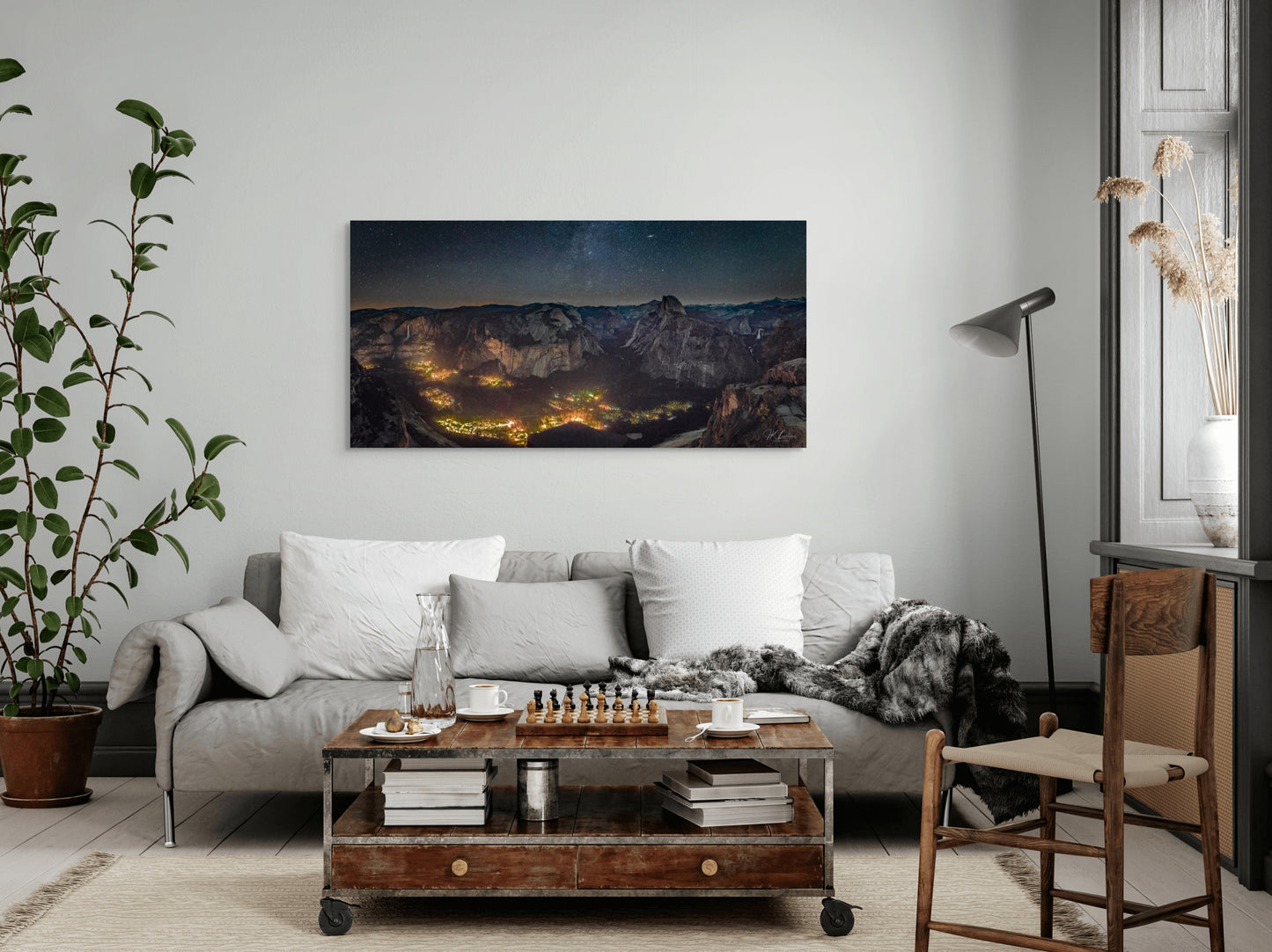 A wall art mockup featuring the photograph titled "Artificial Darkness" by landscape photographer J K Lovelace as a 60 inch wide metal print with inset frame on display in a modern colonial apartment.