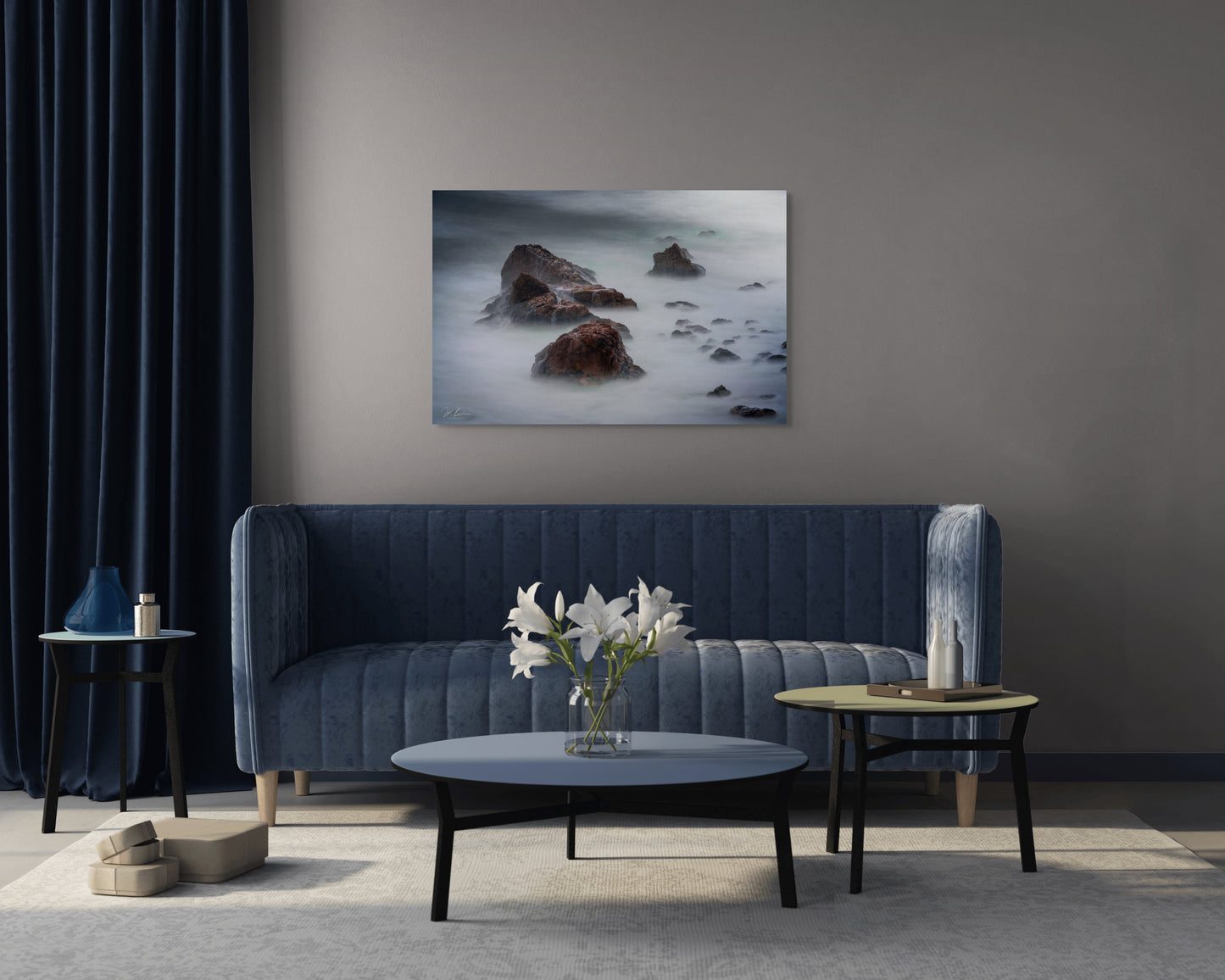 A wall art mockup featuring the photograph titled "Beyond Here Be Dragons" by landscape photographer J K Lovelace as a 44 inch wide metal print with inset frame on display in a modern apartment.