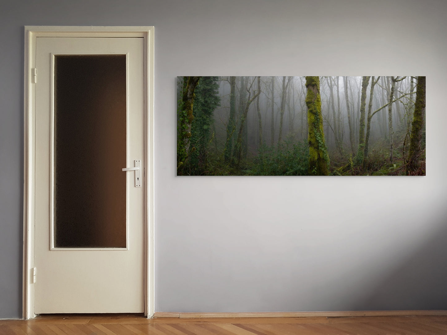 A wall art mockup featuring the photograph titled "Forest Park Ferngully" by landscape photographer Ben Coffman as a 84 inch wide metal print with inset frame on display on a wall next to a door.