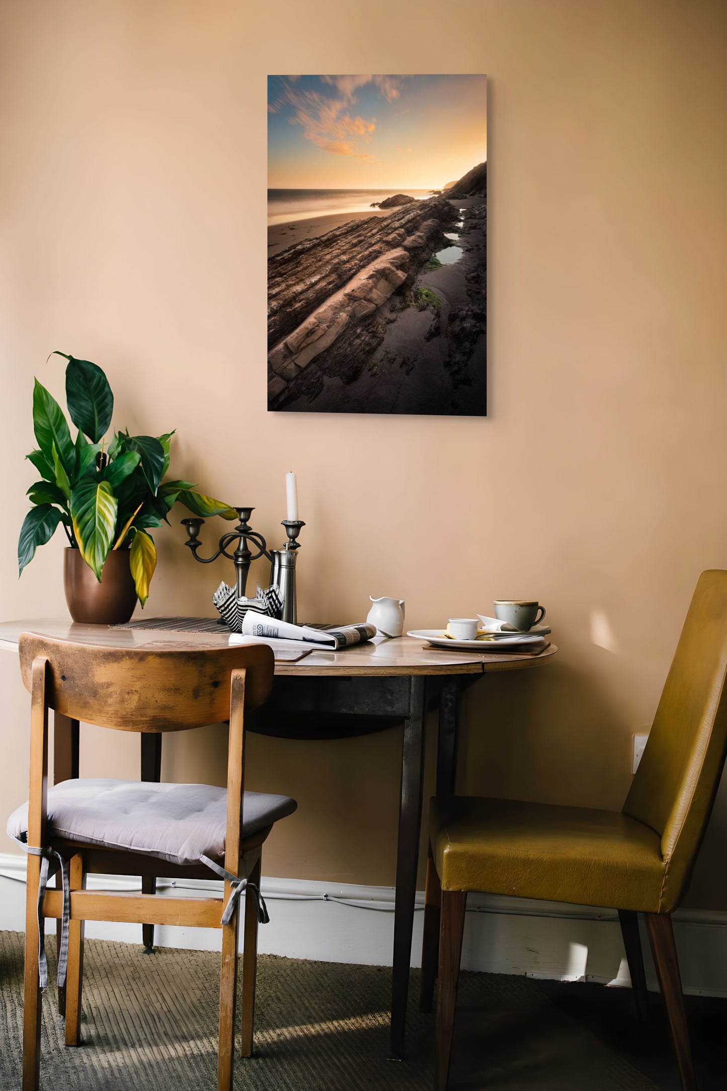 A wall art mockup featuring the photograph titled "Gaviota Sunset" by landscape photographer Ben Coffman as a metal print with inset frame on display in a modern apartment.