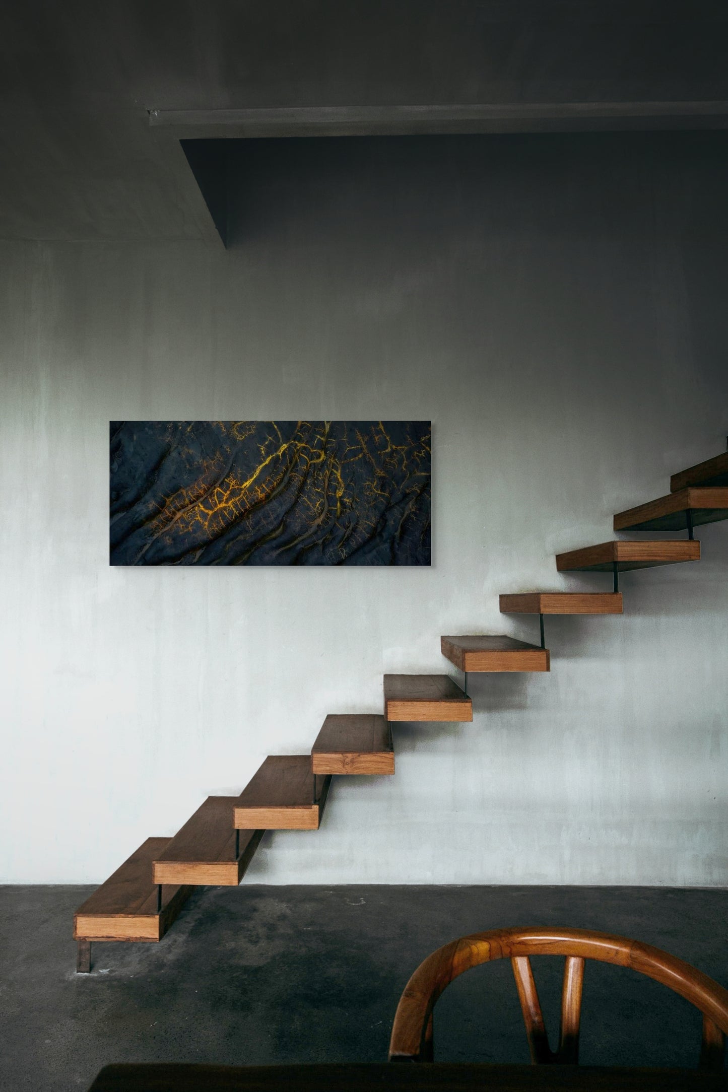 A wall art mockup featuring the photograph titled "Golden Veins" by landscape photographer Ben Coffman as a 48 inch wide metal print with inset frame on display in an industrial loft.