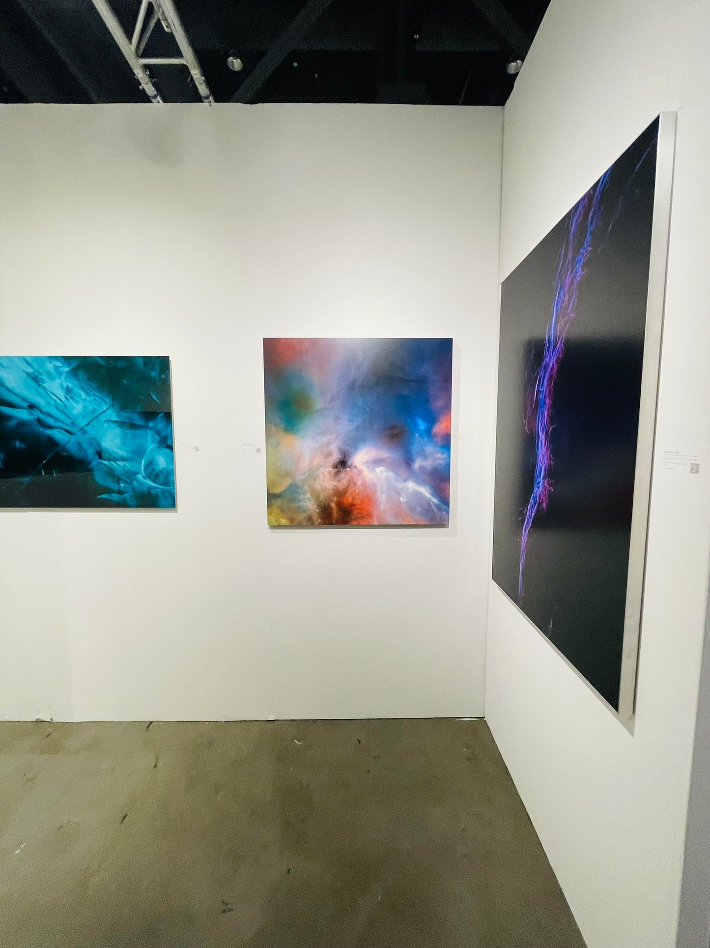 Art gallery with abstract artworks on white walls