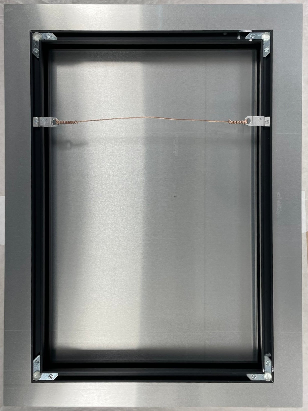 Metallic frame with a central rectangular opening on a white background