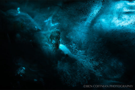 A jpg of the photograph titled "Ice Nebulae I" shot by landscape photographer Ben Coffman, featuring black and blue abstract translucent ice.