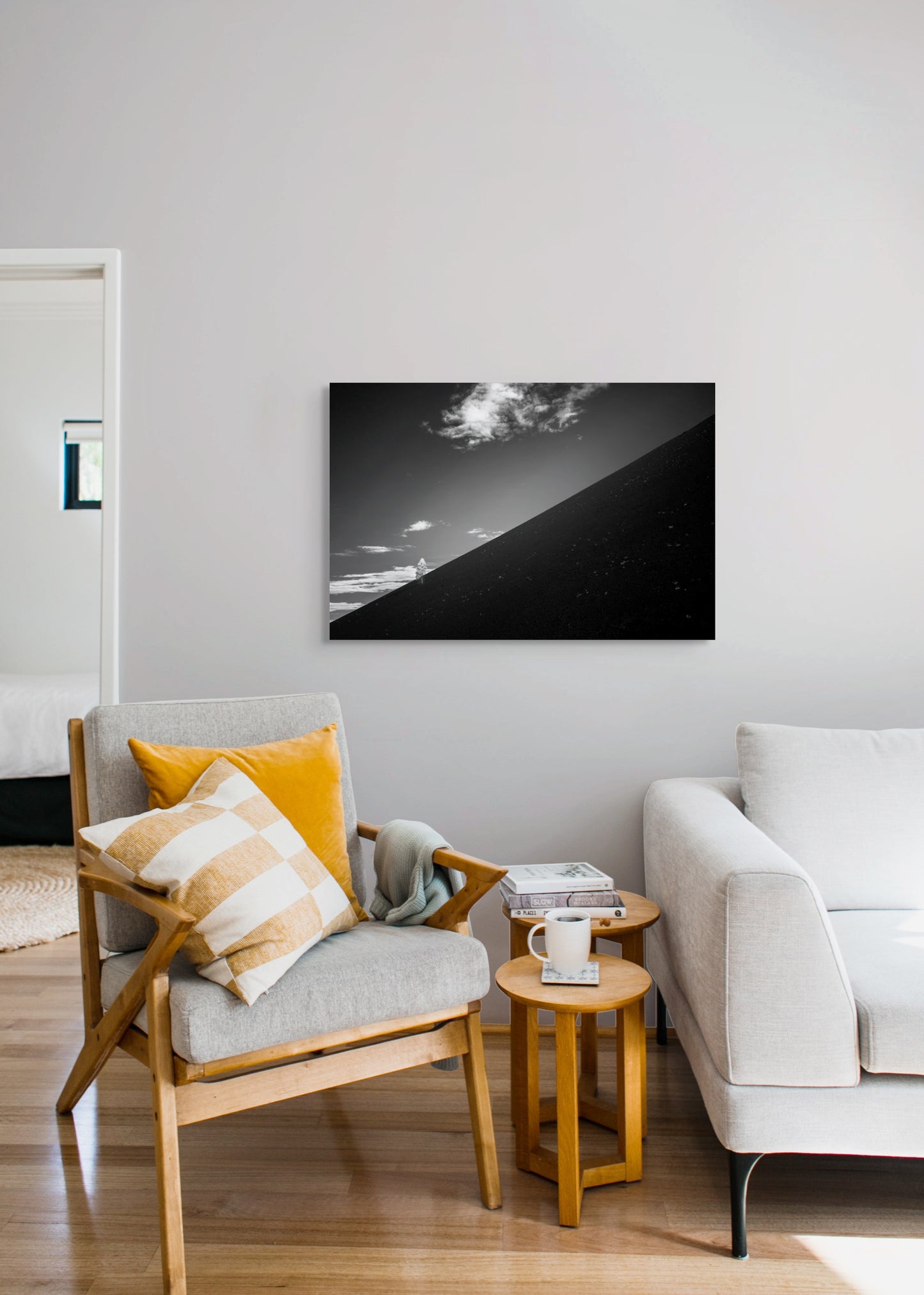 A wall art mockup featuring the photograph titled "Lean" by landscape photographer Ben Coffman as a 36 inch wide metal print with inset frame on display in a modern living room.