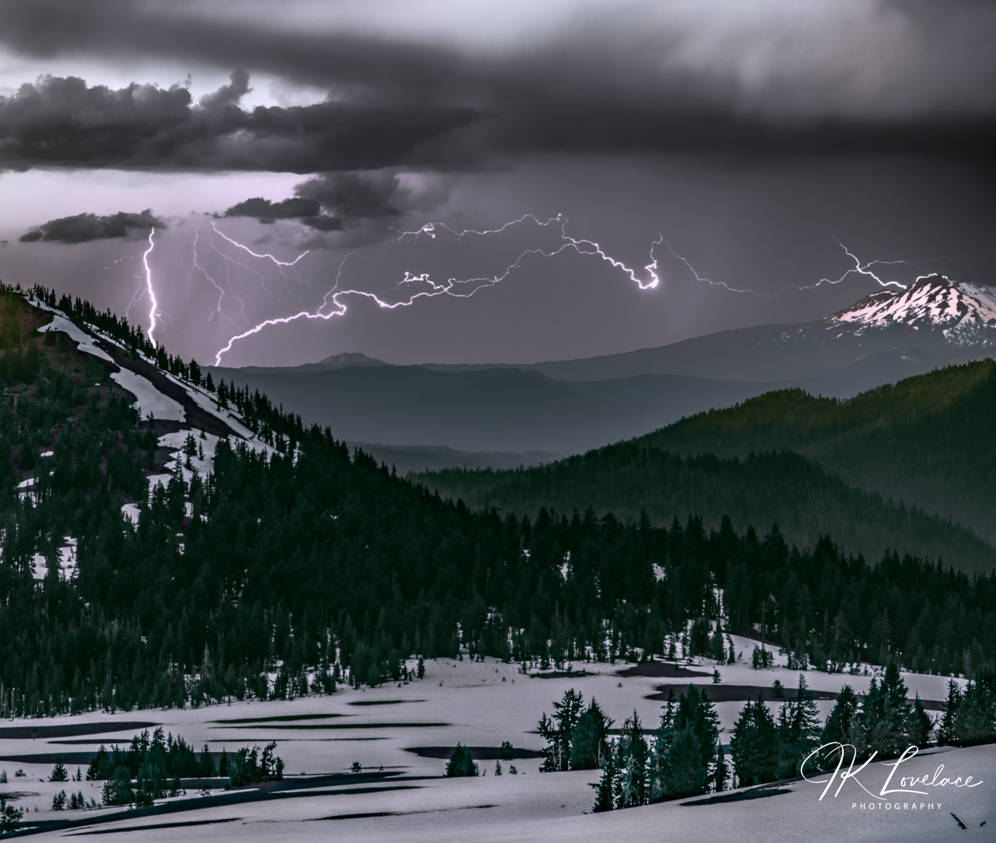 A png of the stormy photograph titled, "Lightning and Ice" shot by landscape photographer J K Lovelace, featuring lightning, mountains, and snow of Cascades, Oregon.