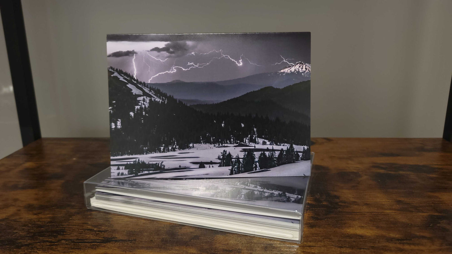 A photograph of a holiday greeting card set featuring the photograph titled "Lightning and Ice" on the front cover