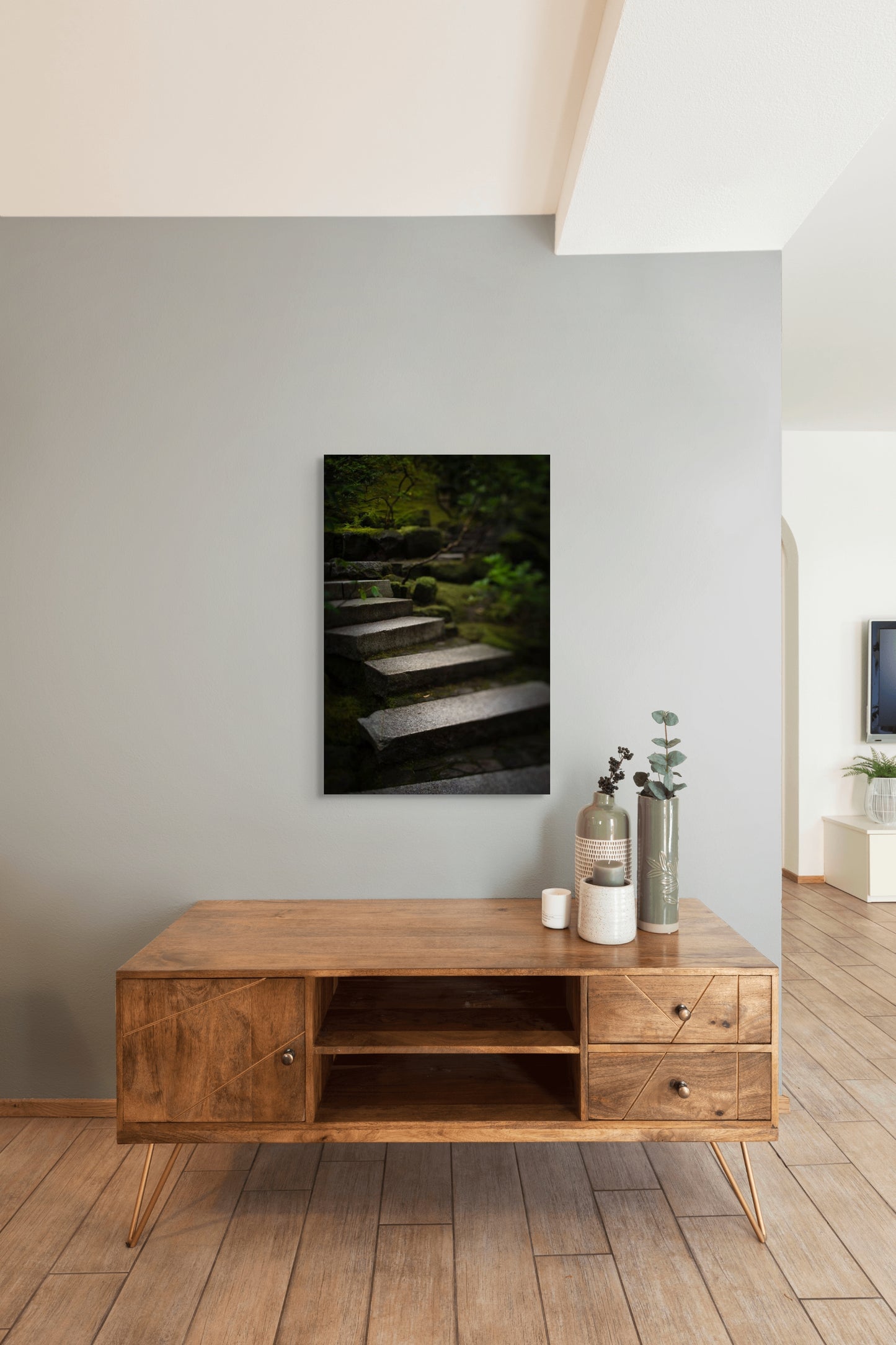 A wall art mockup featuring the photograph titled "Liminal Spaces in the Portland Japanese Garden 10" by landscape photographer Ben Coffman as a 24 inch wide metal print with inset frame on display in a modern home.