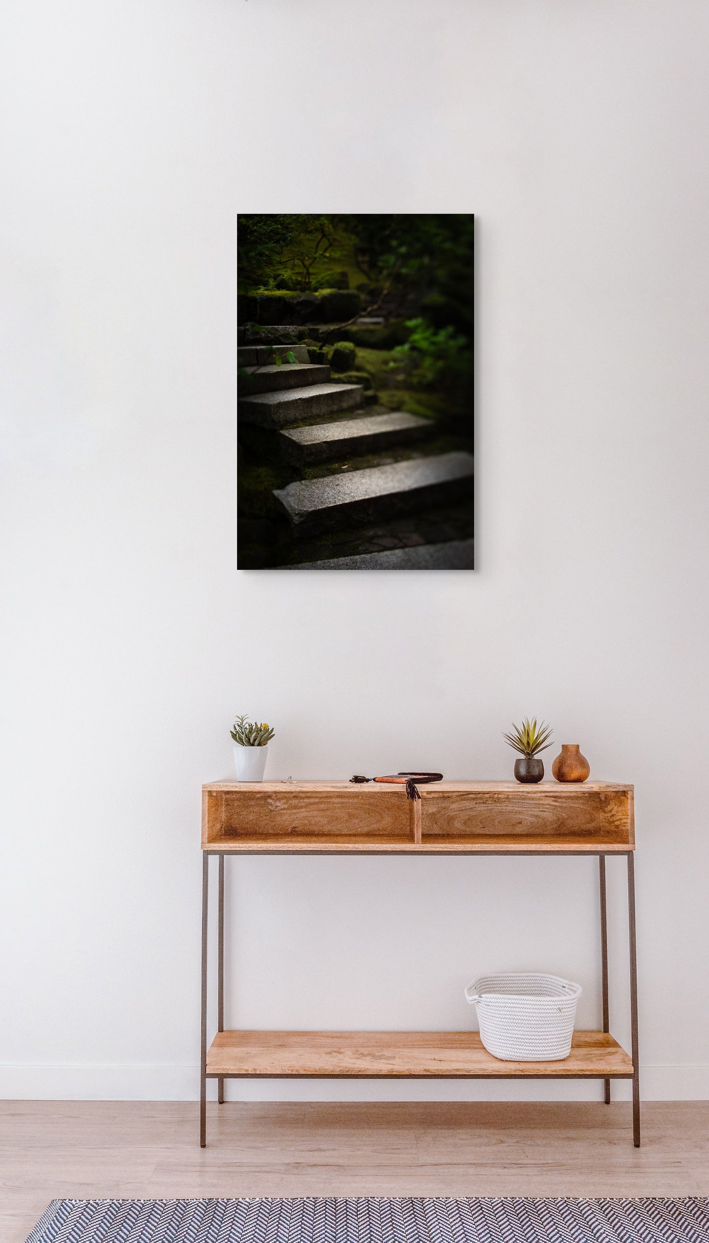 A wall art mockup featuring the photograph titled "Liminal Spaces in the Portland Japanese Garden 10" by landscape photographer Ben Coffman as a 20 inch wide metal print with inset frame on display in modern apartment.