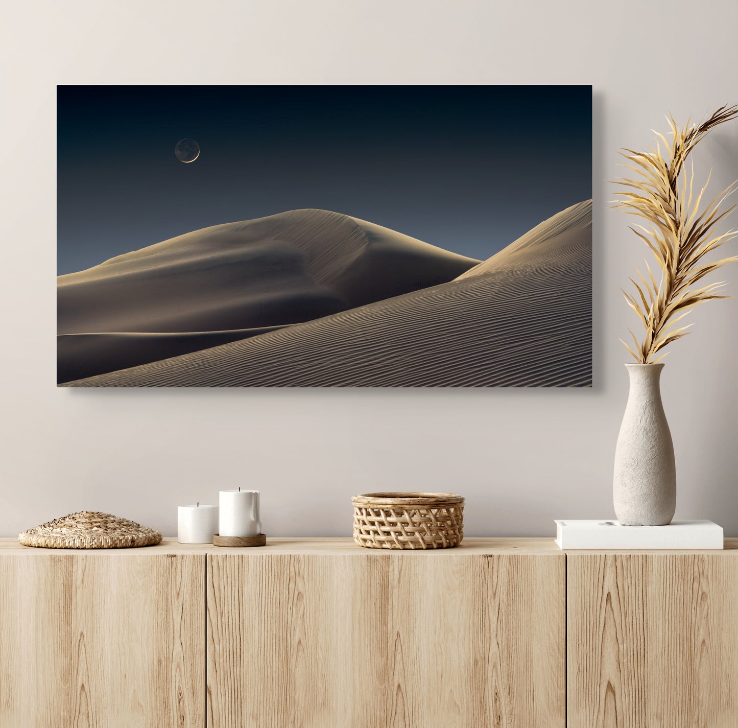 A wall art mockup featuring the photograph titled "Luna Dunes" by landscape photographer J K Lovelace as a 30 inch wide metal print with inset frame on display above an unfinished wood console cabinet.