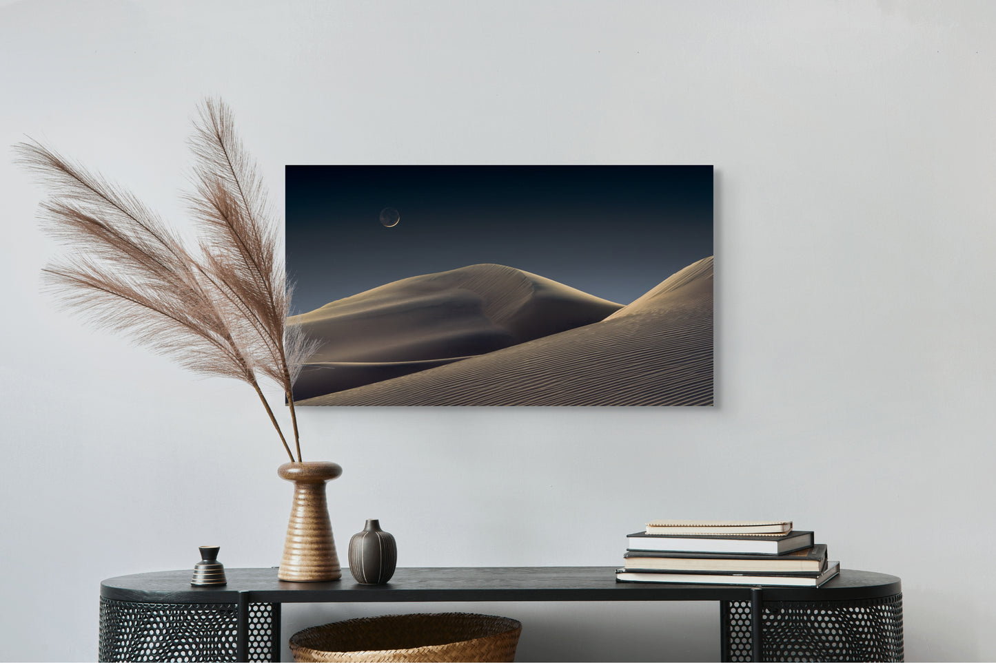 A wall art mockup featuring the photograph titled "Luna Dunes" by landscape photographer J K Lovelace as a 36 inch wide metal print with inset frame on display above black console table.
