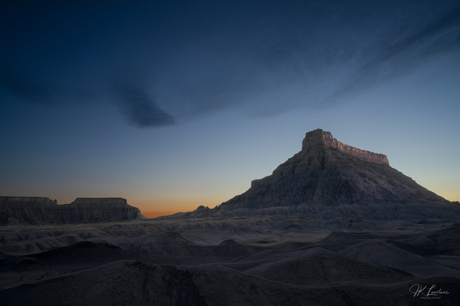 A jpg of the blue hour grand scenic photograph titled "Night Shift" shot by landscape photographer J K Lovelace featuring badlands at dusk