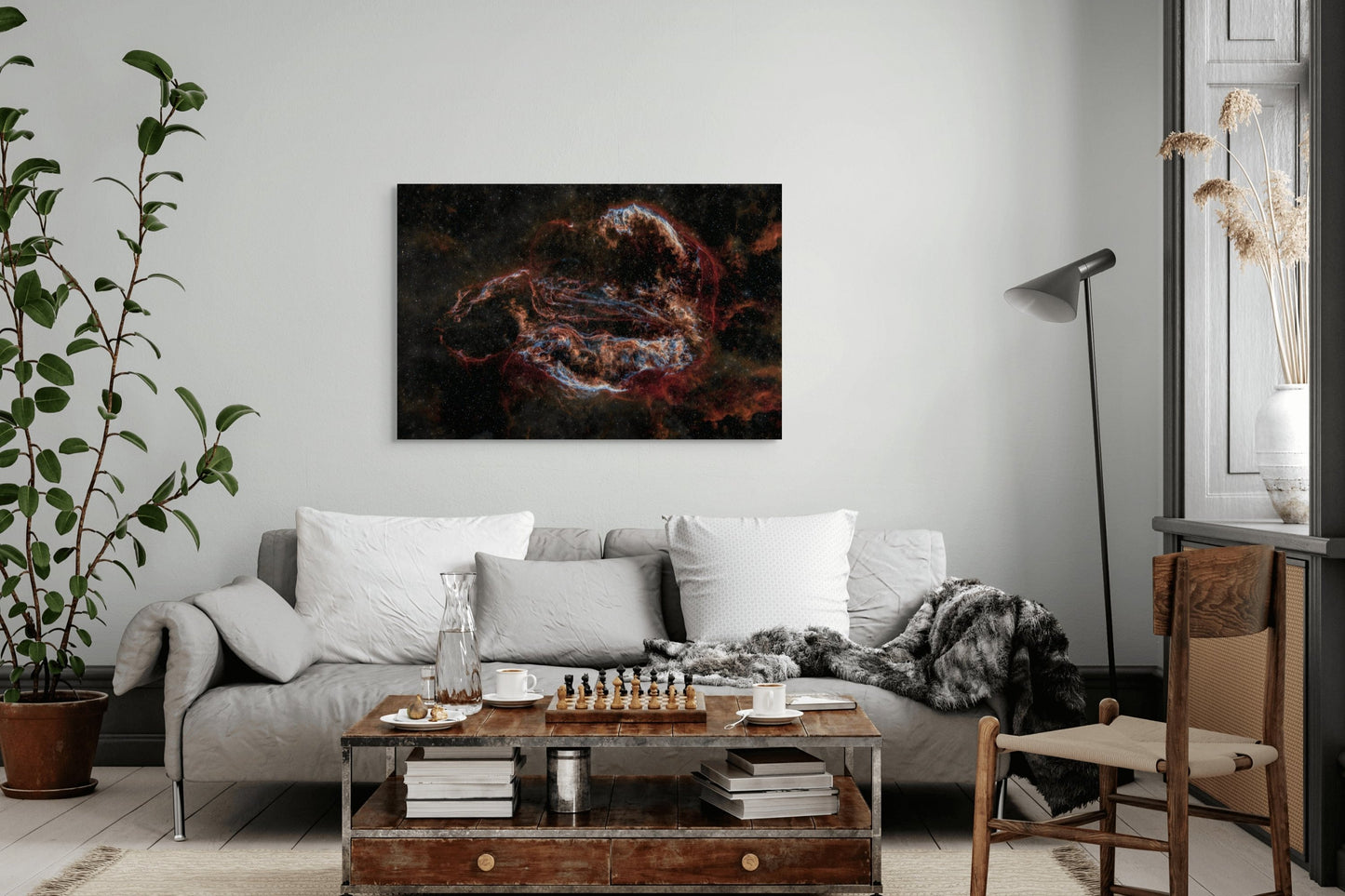 A wall art mockup featuring the 44 inch wide metal print titled "Ouroboros" on display above a light gray sofa in a modern colonial apartment.