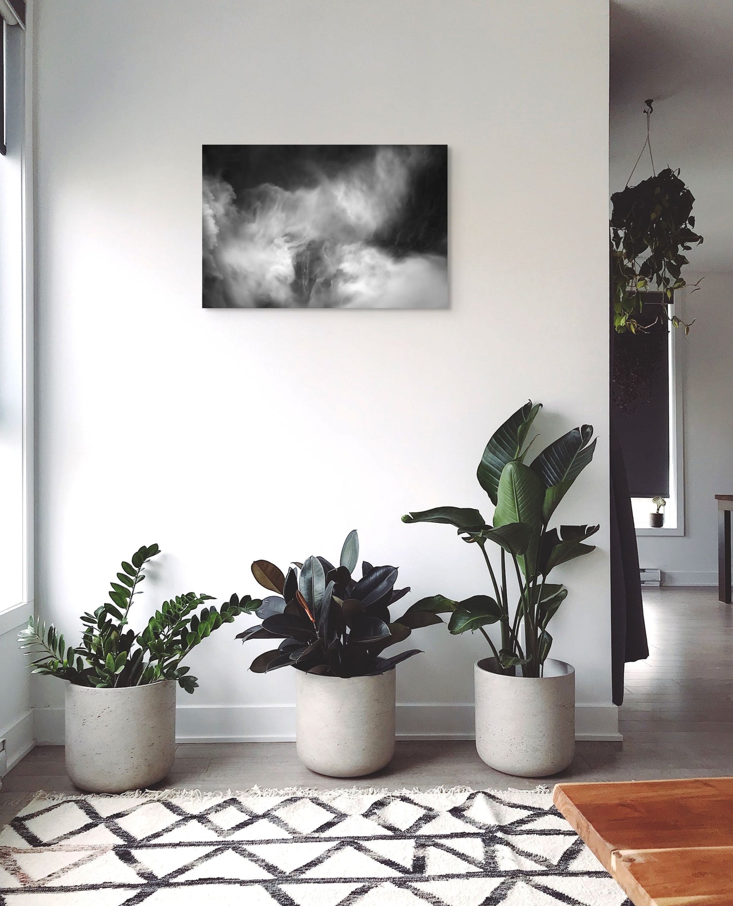 A wall art mockup featuring the photograph titled "Roar Shock I" by landscape photographer Ben Coffman as a 30 inch wide metal print with inset frame on display in a modern apartment.