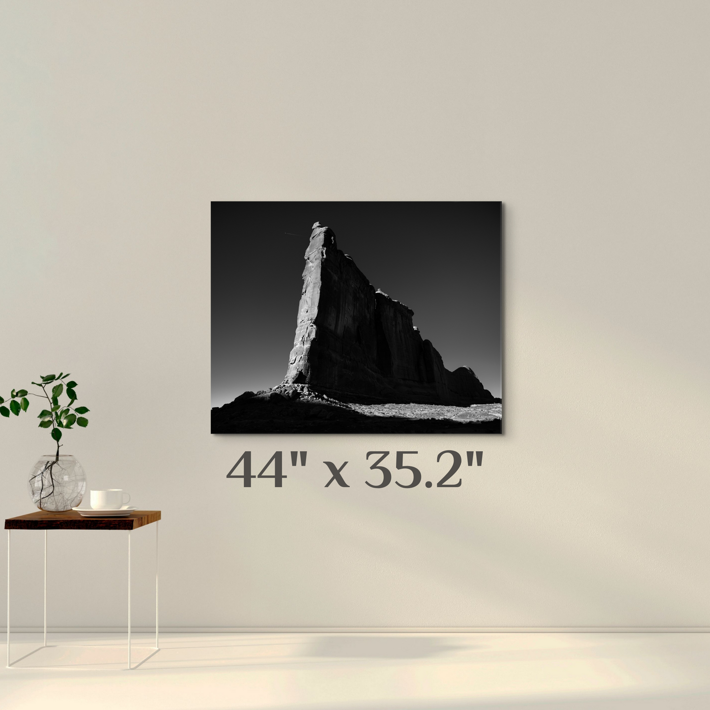 A wall art mockup featuring the black and white photograph titled, "Tower of Babel" shot by landscape photographer J K Lovelace, as a 44 inch wide metal print with inset frame on wall in a room.