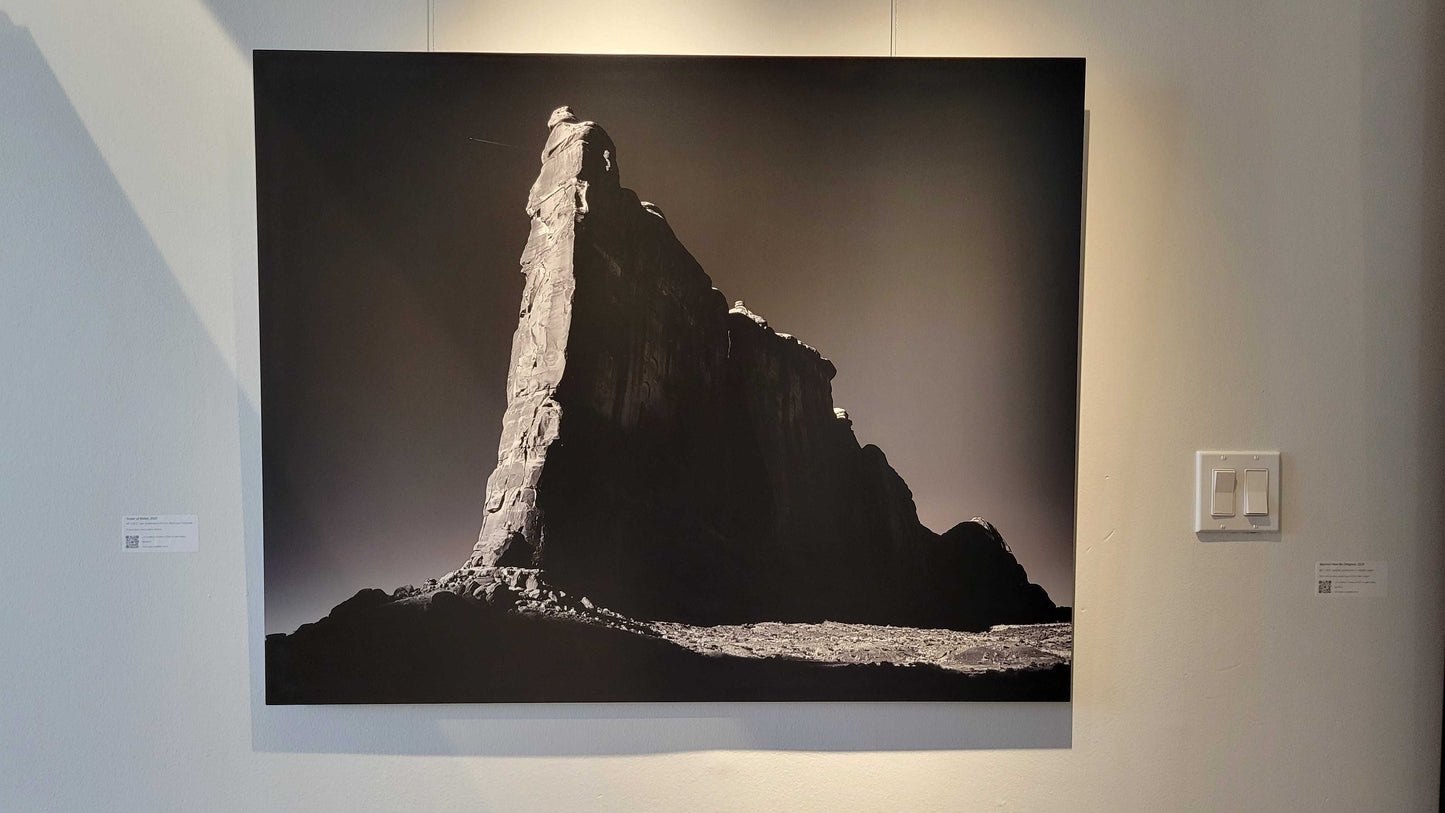 A photograph of the metal print titled "Tower of Babel" on display at Slice of Light Gallery.