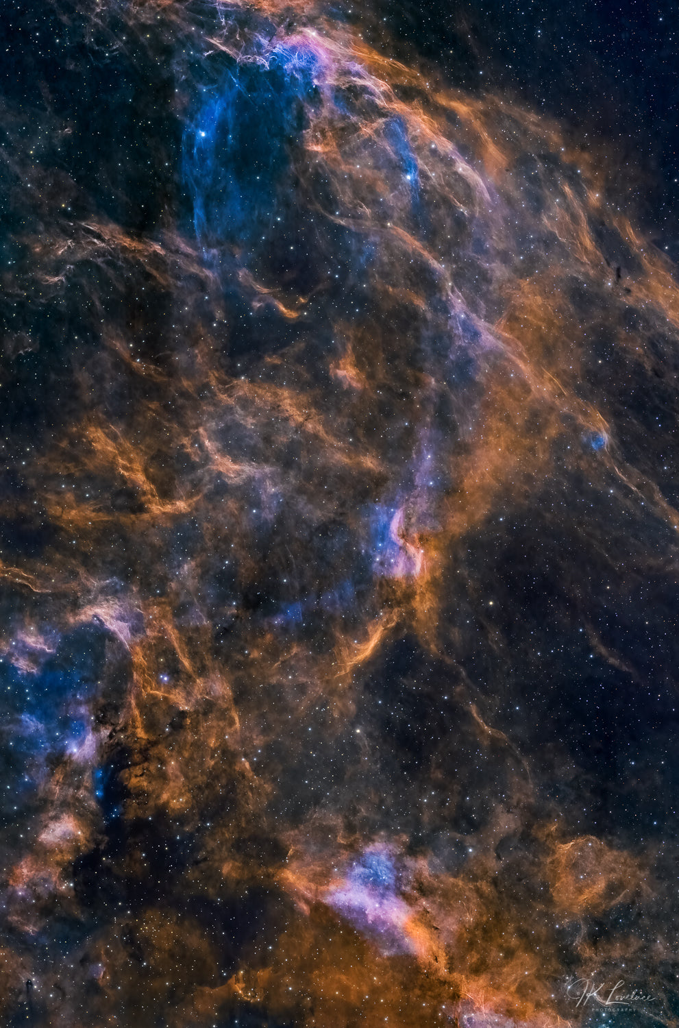 A jpg of the astrophotograph titled "DWB 111/Double Helix" shot by astrophotographer J K Lovelace featuring twisting cosmic clouds of the Cygnus-X star forming region.