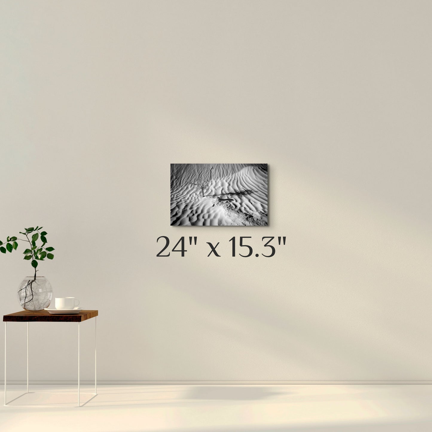 A simple wall art mockup featuring the 24 inch wide metal print titled "Death in Dunes" on display on a wall.