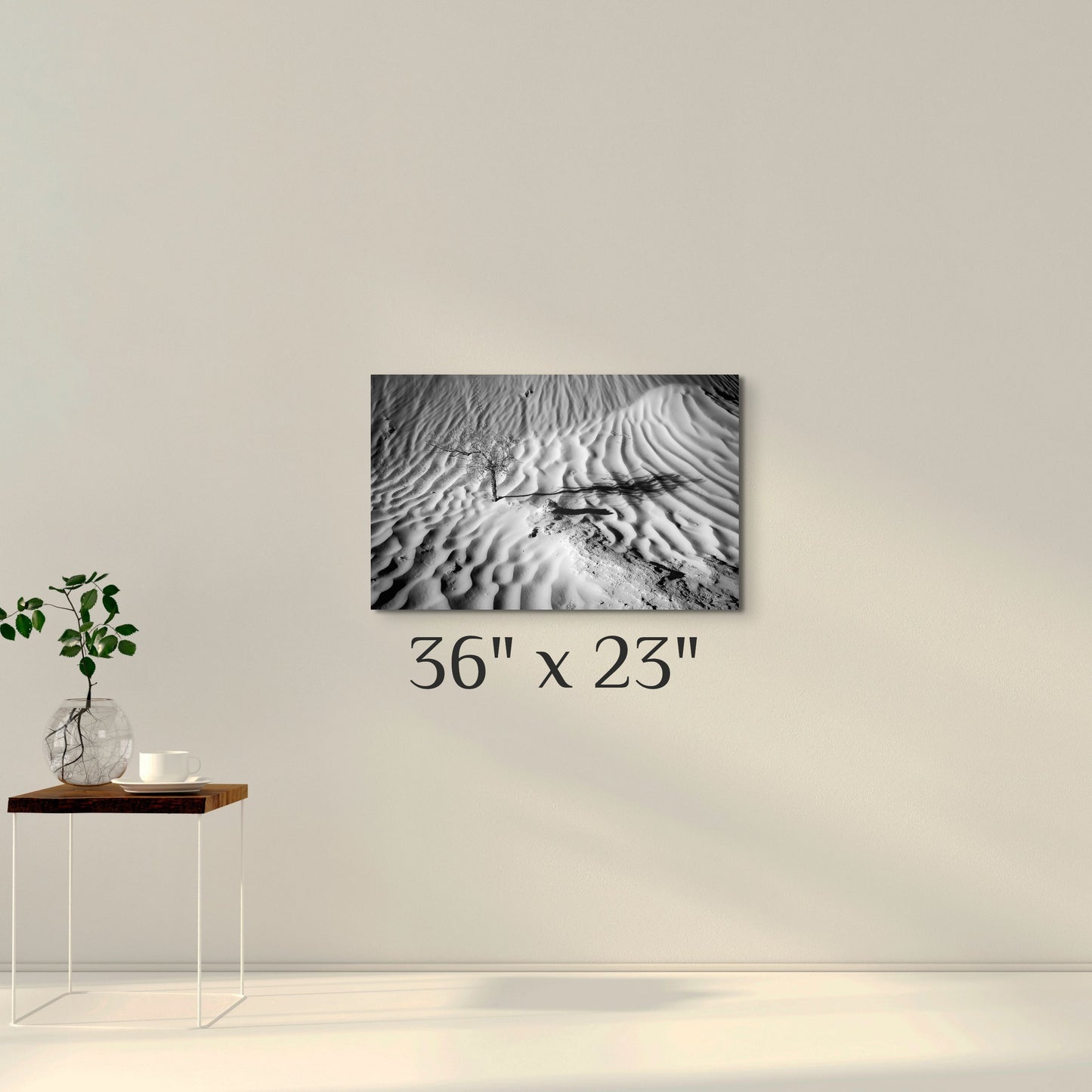 A simple wall art mockup featuring the 36 inch wide metal print titled "Death in Dunes" on display on a wall.