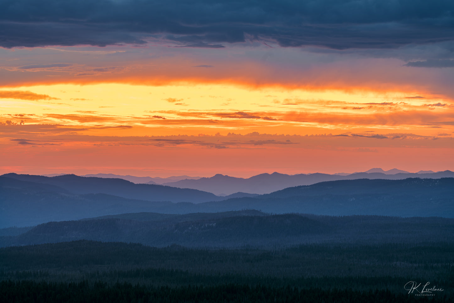 A jpg of the nightscape panoramic photograph titled "Melting Into Saffron" shot by landscape photographer J K Lovelace featuring Crater Lake National Park at sunset