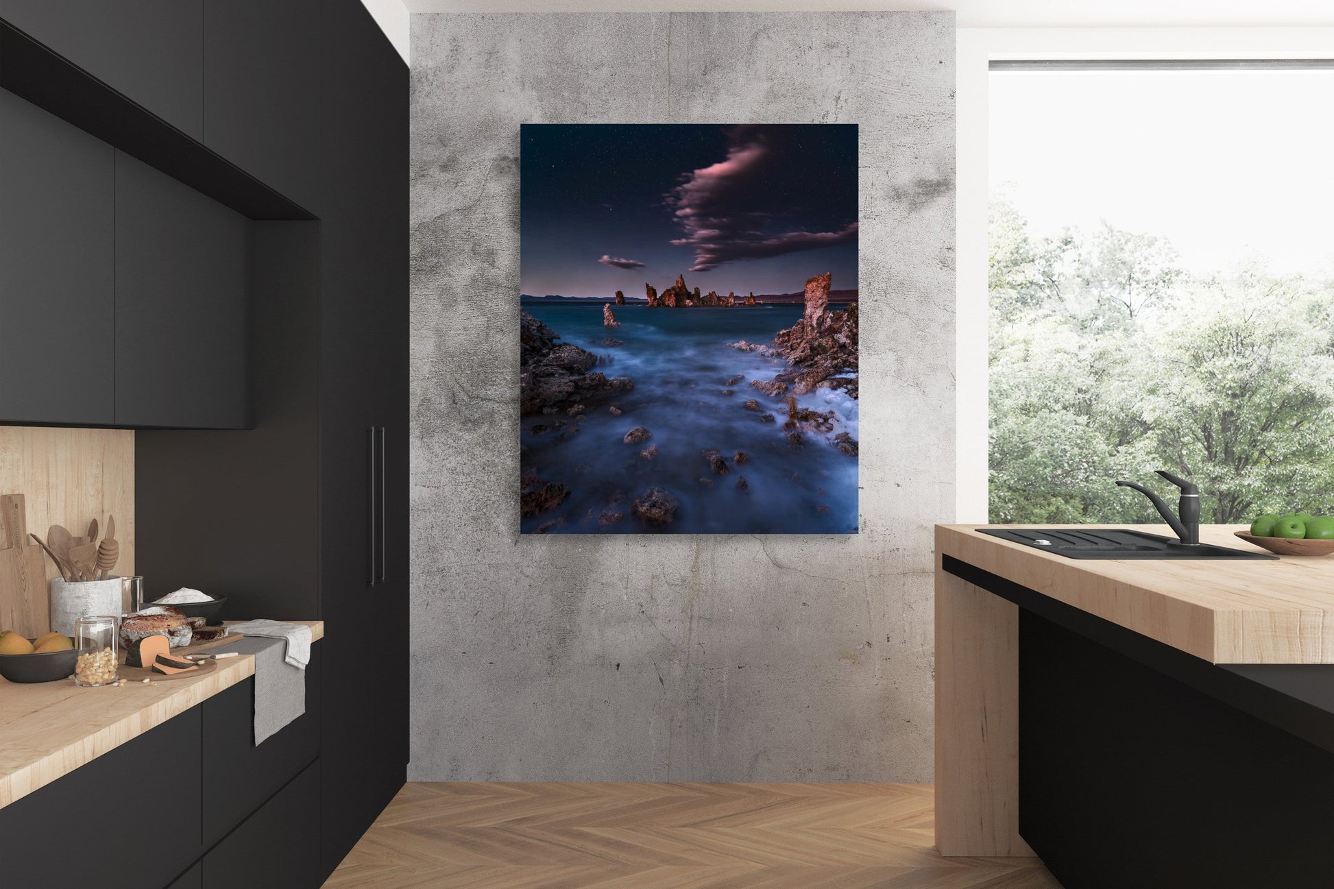A wall art mockup of the metal print titled "Mono Lith" in inset frame displayed on a cement wall in an industrial modern style kitchen with black and natural wood finishes.
