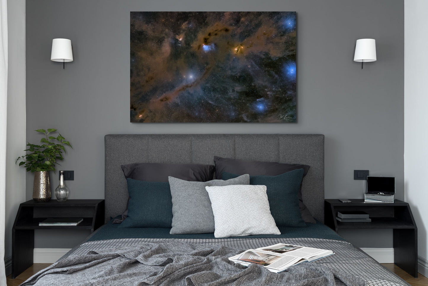 A wall art mockup featuring the 44 inch wide metal print in inset frame titled "Nebulas LBN 782 and Barnard 7" on display in a dark colored contemporary bedroom.