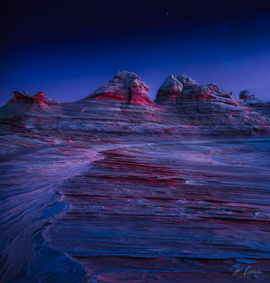 A jpg of the nightscape vertical panoramic photograph titled "The Red of Night" shot by landscape photographer J K Lovelace featuring rock formations that resemble an alien landscape