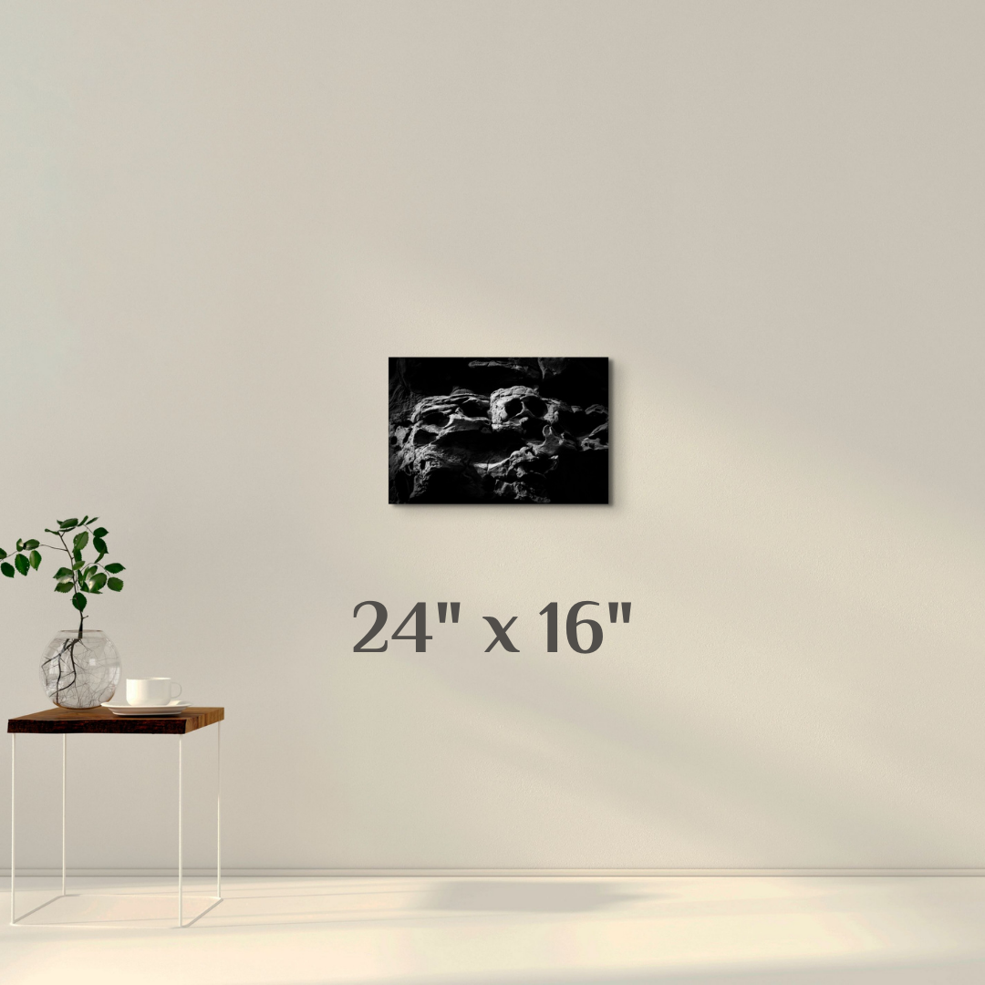 A simple wall art mockup featuring the 24 inch wide metal print titled "The Skull of Ozymandias" displayed on a wall.