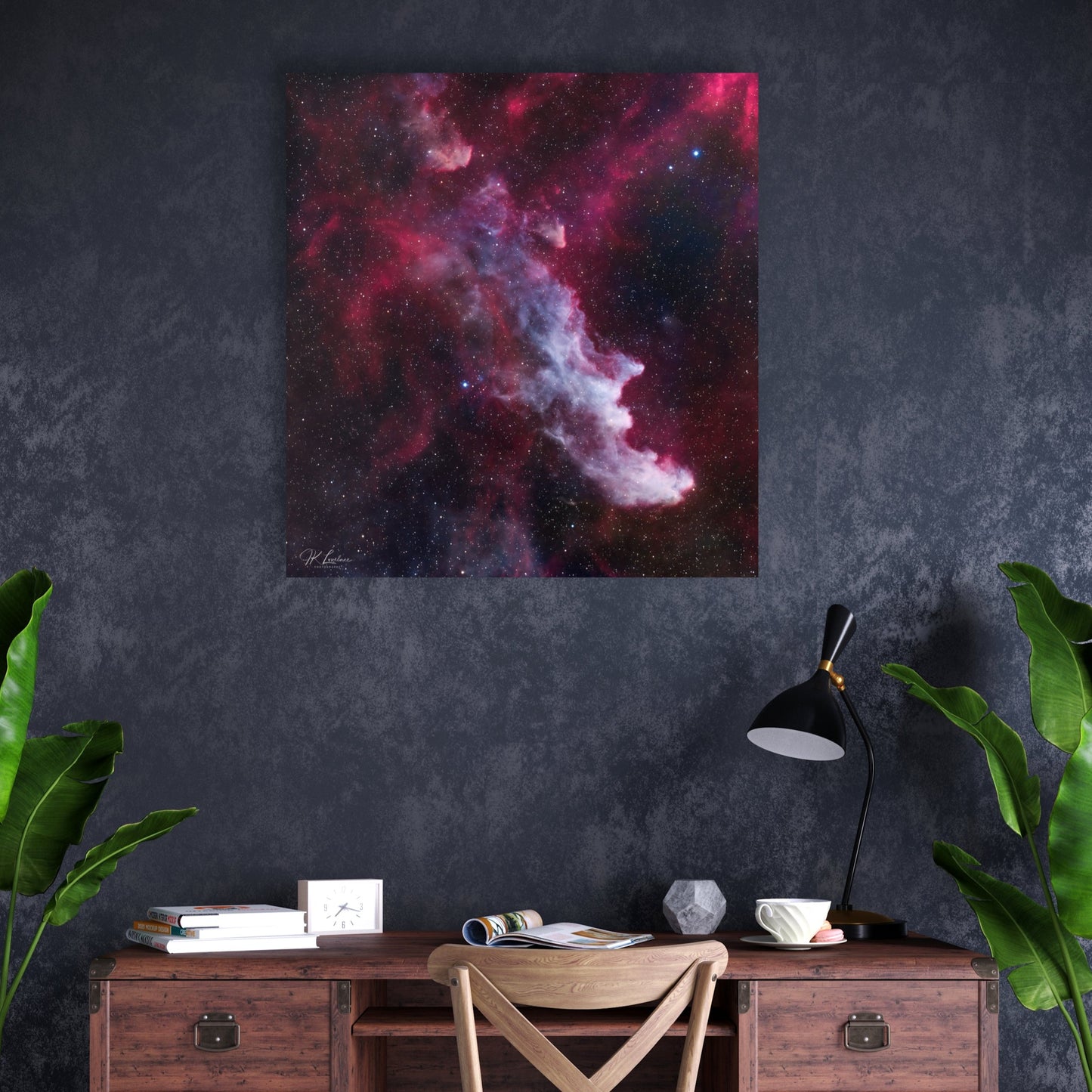 A wall art mockup of the metal print titled "The Wicked Witch of Orion" in an inset frame above an industrial wood writing desk in a dark gray and blue wall papered wall.