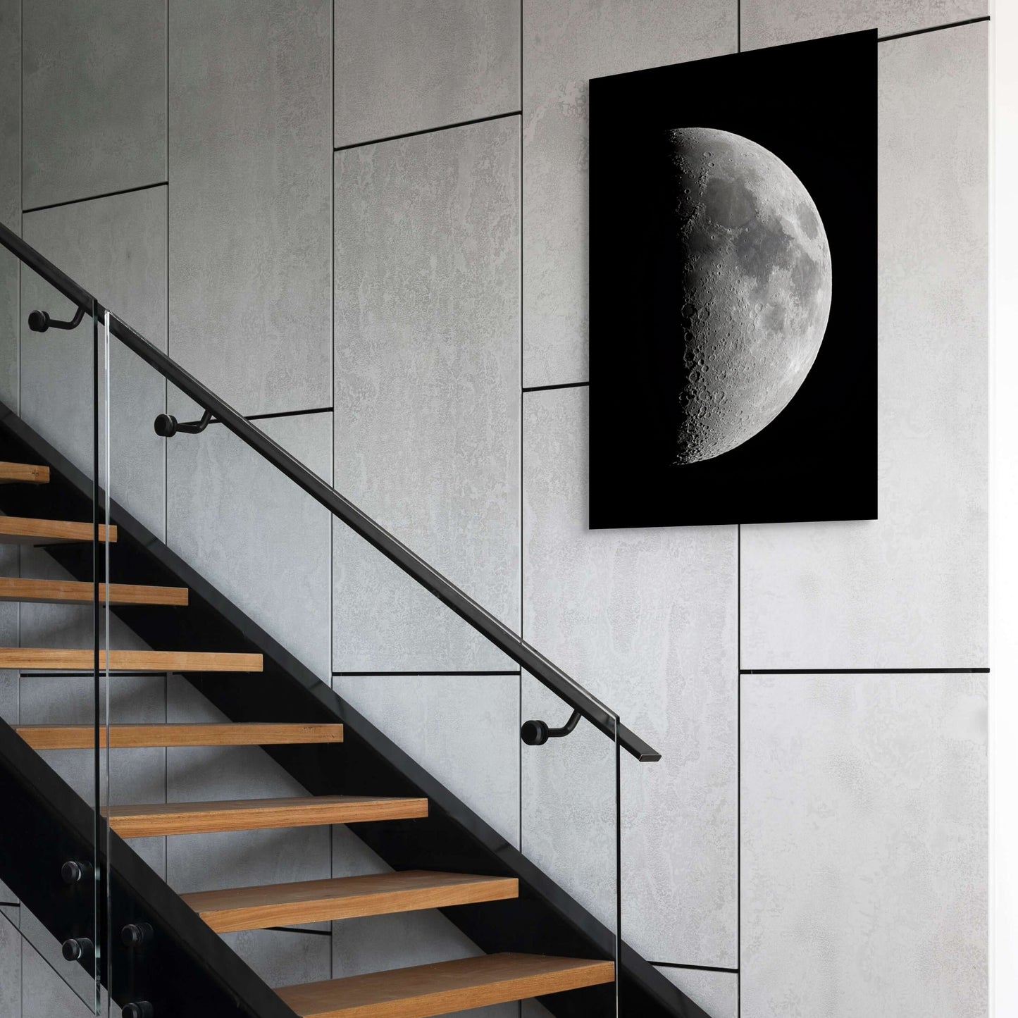 A wall art mockup featuring the 20 inch metal print titled "1st Quarter Moon" on display above a staircase in an industrial modern space.