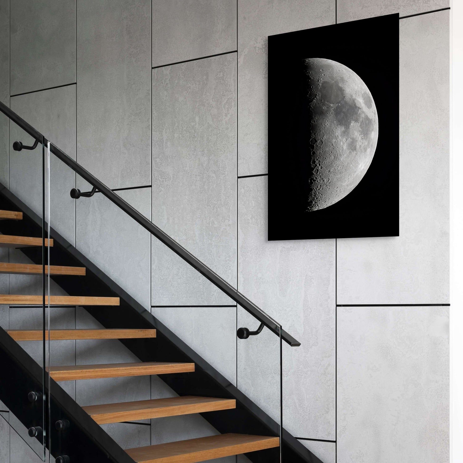 A wall art mockup featuring the 20 inch metal print titled "1st Quarter Moon" on display above a staircase in an industrial modern space.