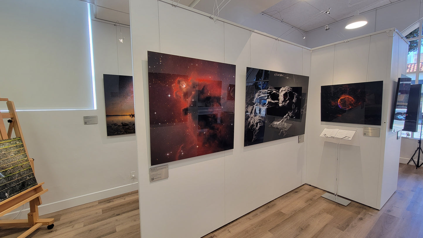 Art gallery with large space-themed artworks on white walls