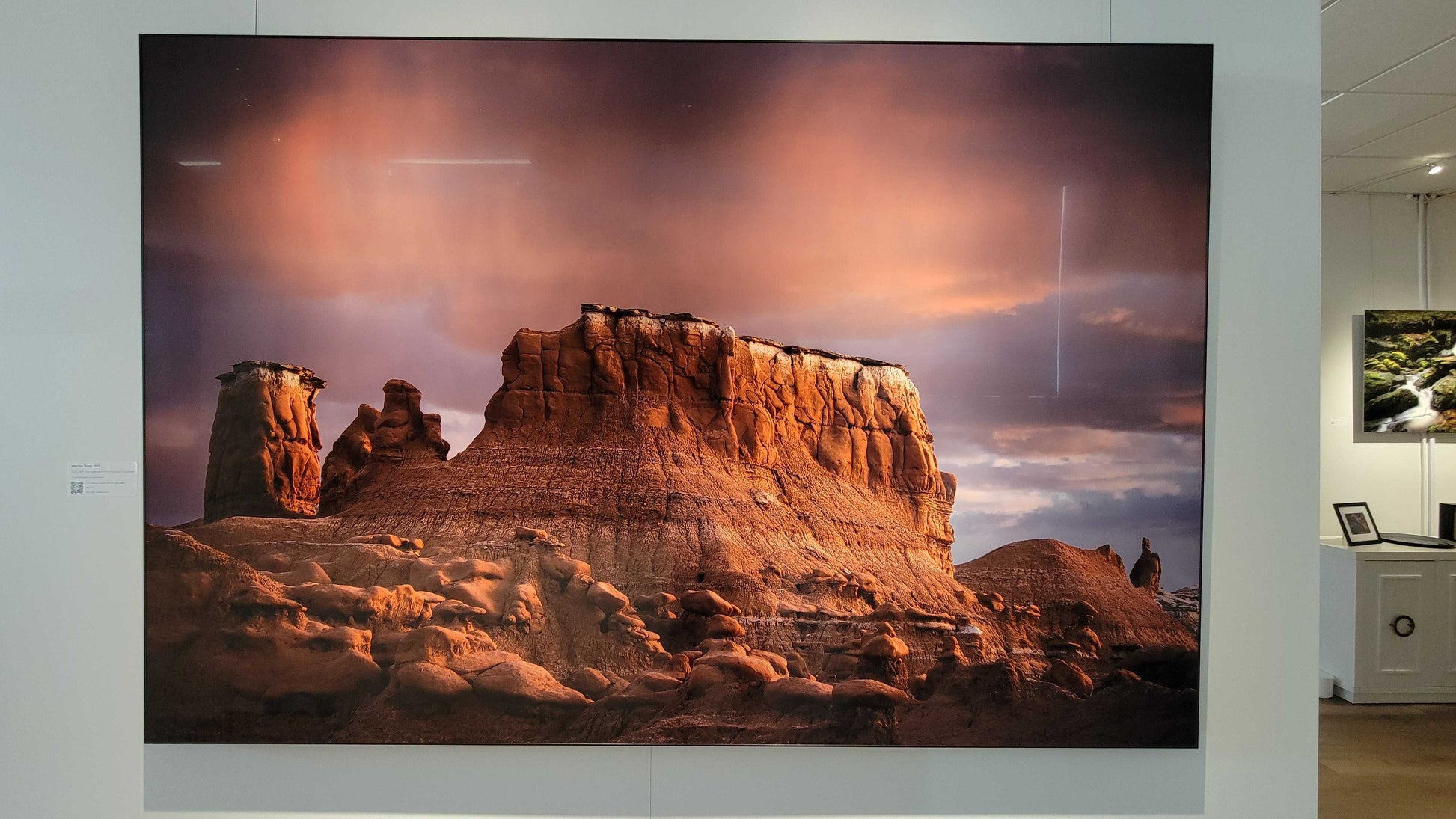 A photograph of the metal print titled "After the Storm" on display in Slice of Light Gallery