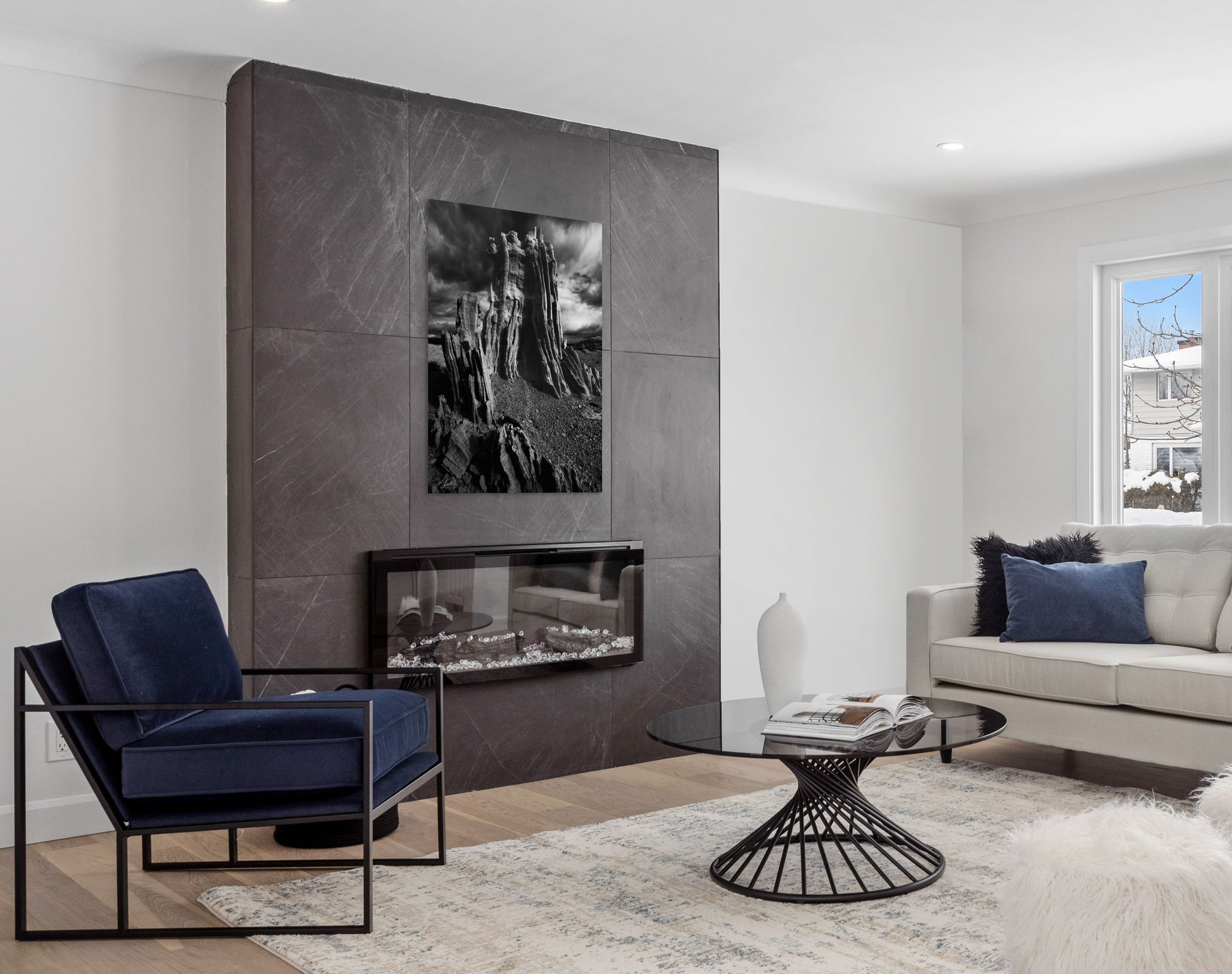 A wall art mockup featuring the photograph titled "Ancient Tower" by landscape photographer J K Lovelace as a 44 inch wide metal print with inset frame on display in a modern den.