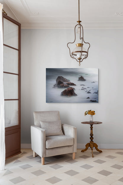 A wall art mockup featuring the photograph titled "Beyond Here Be Dragons" by landscape photographer J K Lovelace as a 44 inch wide metal print with inset frame on display in a traditional home.