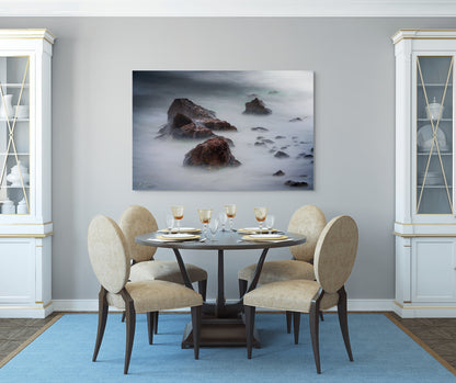 A wall art mockup featuring the photograph titled "Beyond Here Be Dragons" by landscape photographer J K Lovelace as a 60 inch wide metal print with inset frame on display in a traditional dining room.
