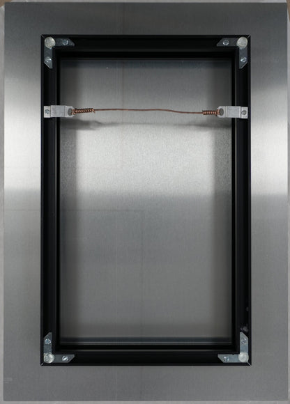 Metallic rectangular object with wires on a brown background