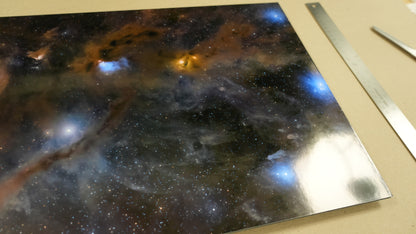 Metallic surface with starry night design and ruler for scale