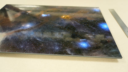 Space-themed decorative panel with nebula design on a white surface