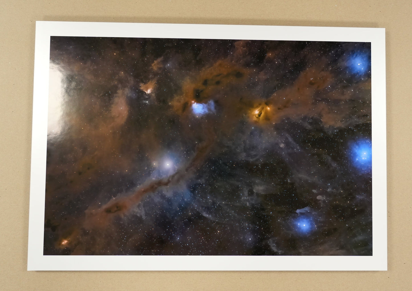 Framed photograph of a starry space scene on a beige wall.