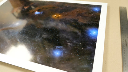 Space-themed artwork on a white background with a ruler for scale.