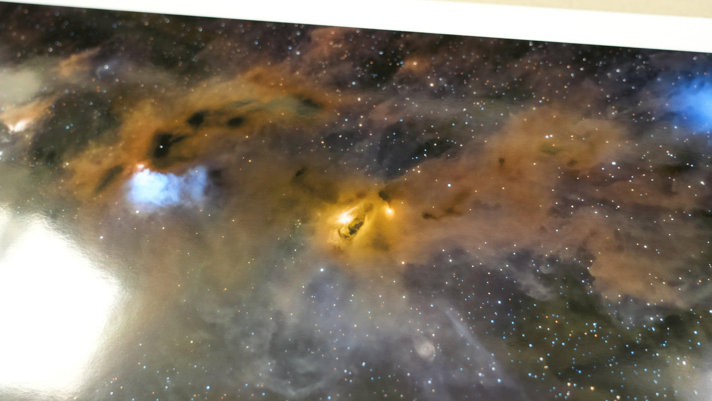 Star-forming region in space with bright young stars and glowing gas clouds.