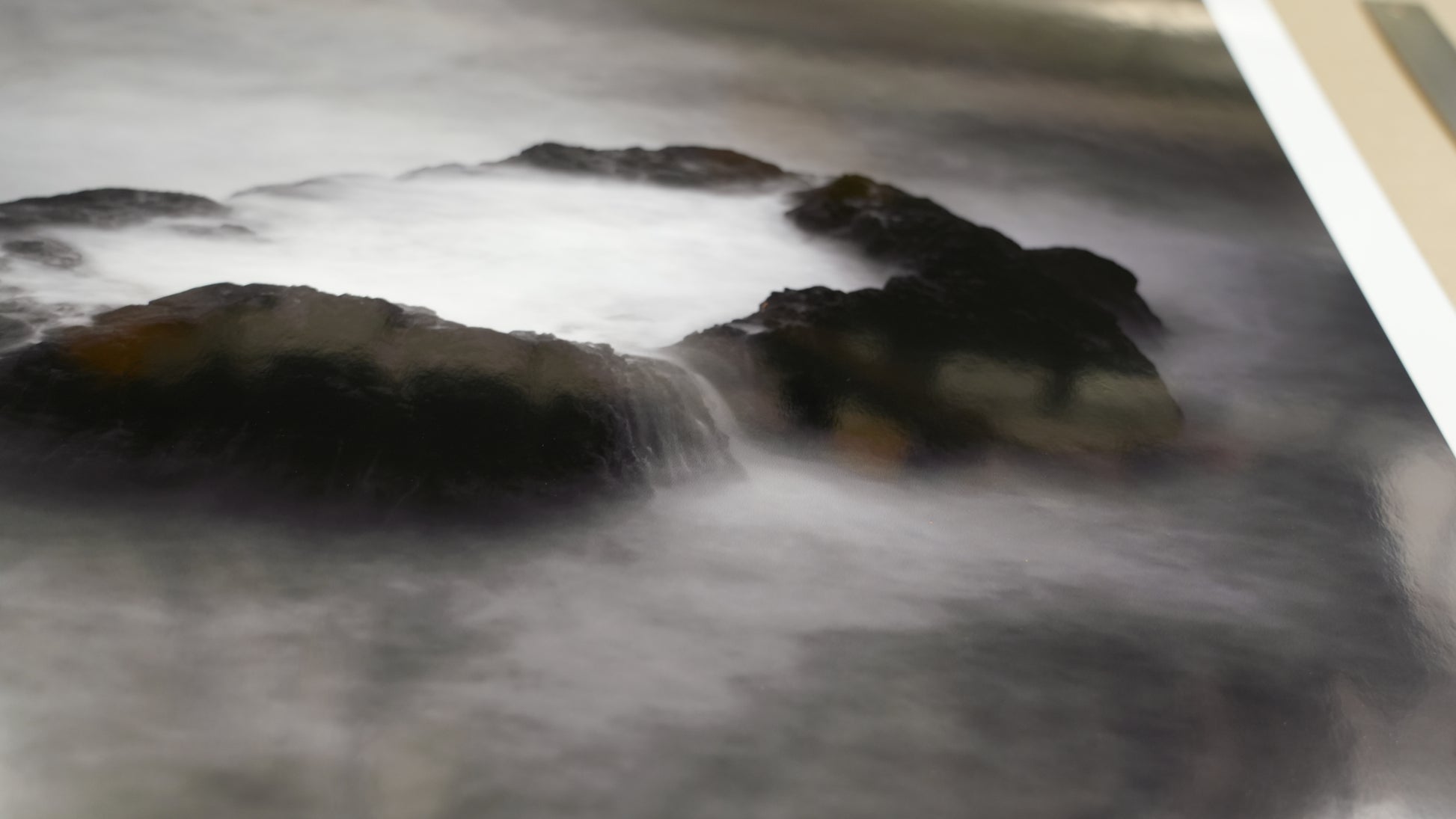 Rocks with water flowing over them on a gray background