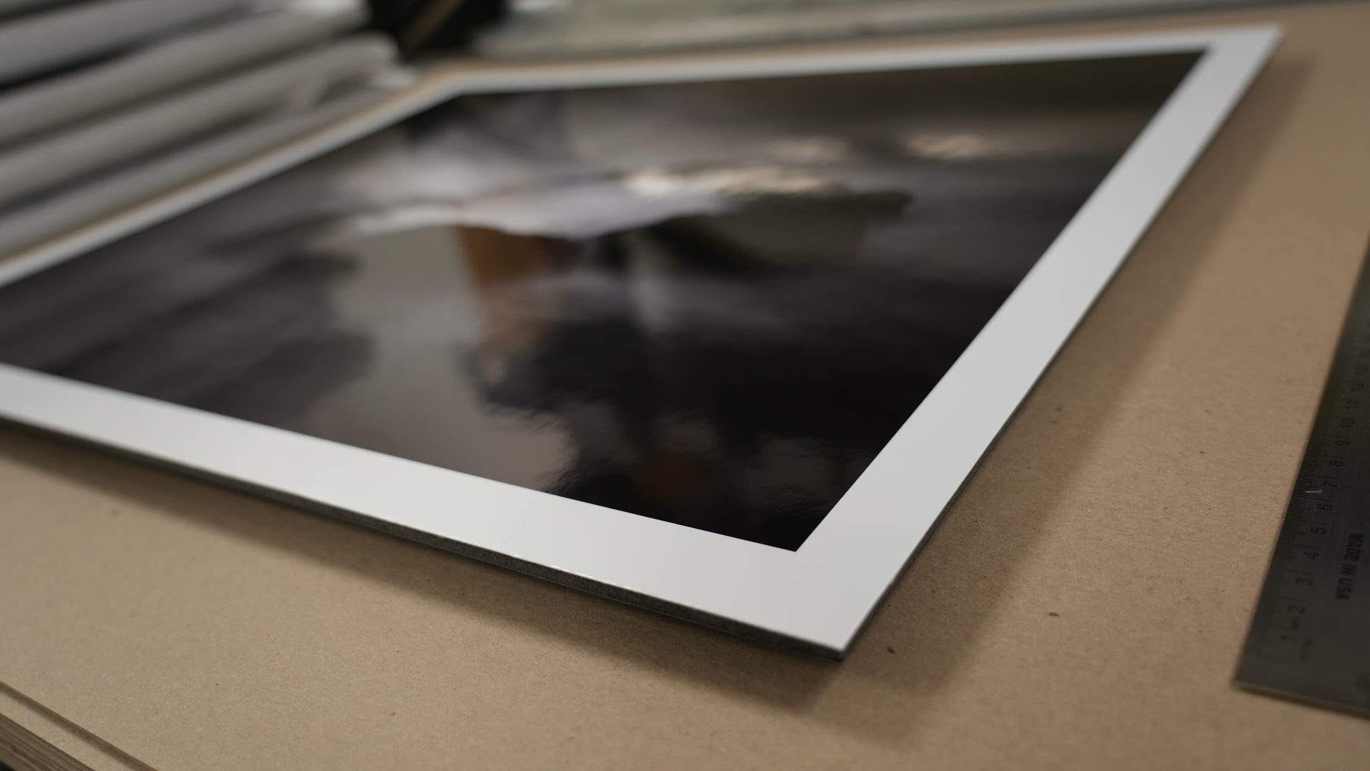 Close-up of a framed photograph on a cardboard surface