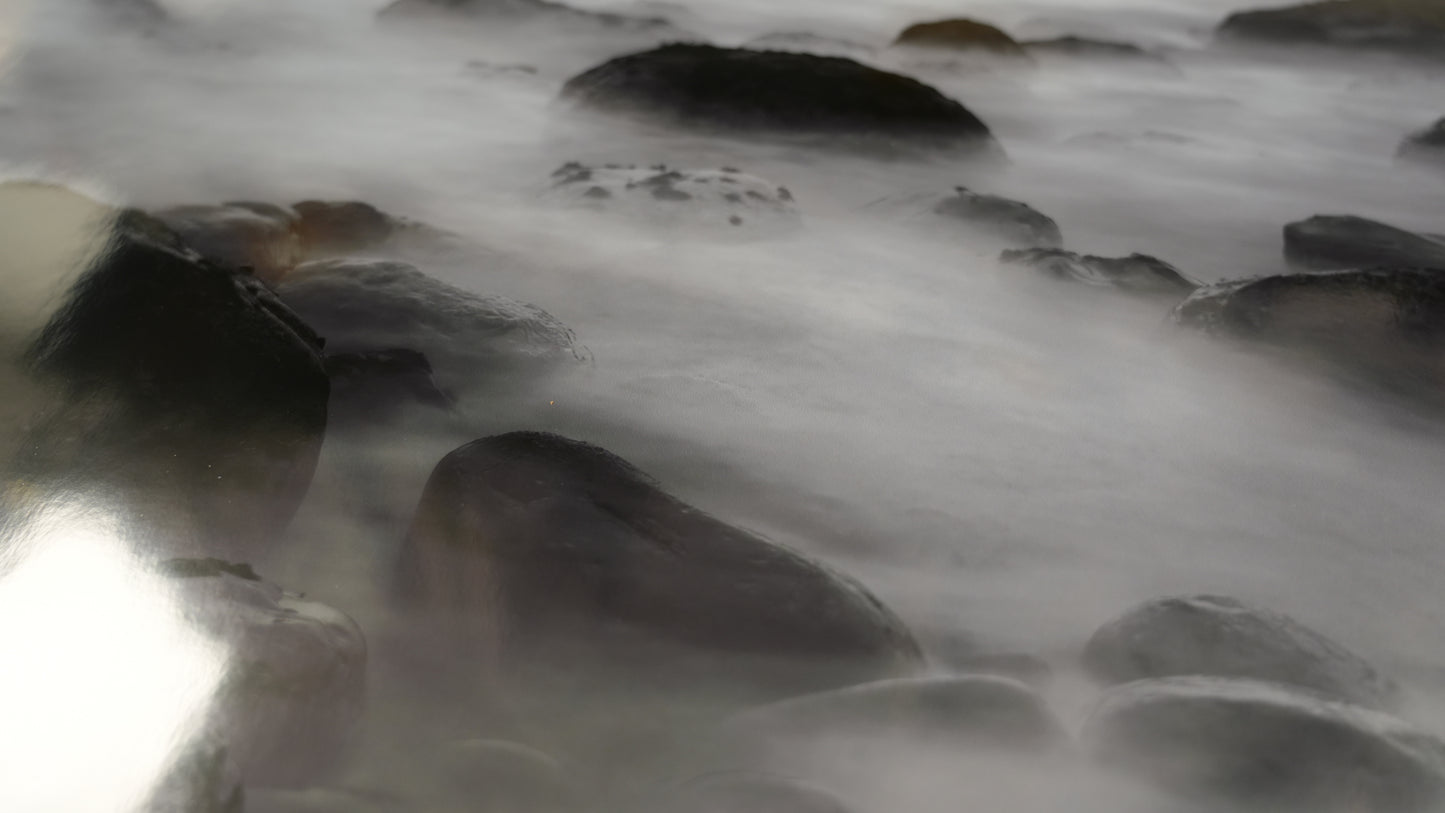 Close-up of flowing water over rocks