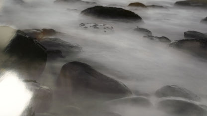 Close-up of flowing water over rocks