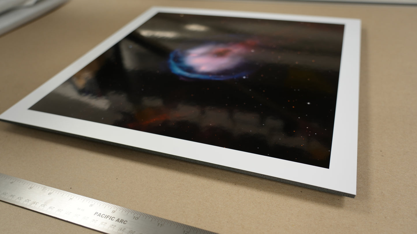 Astrophotograph of a nebula on a table with a ruler for scale.