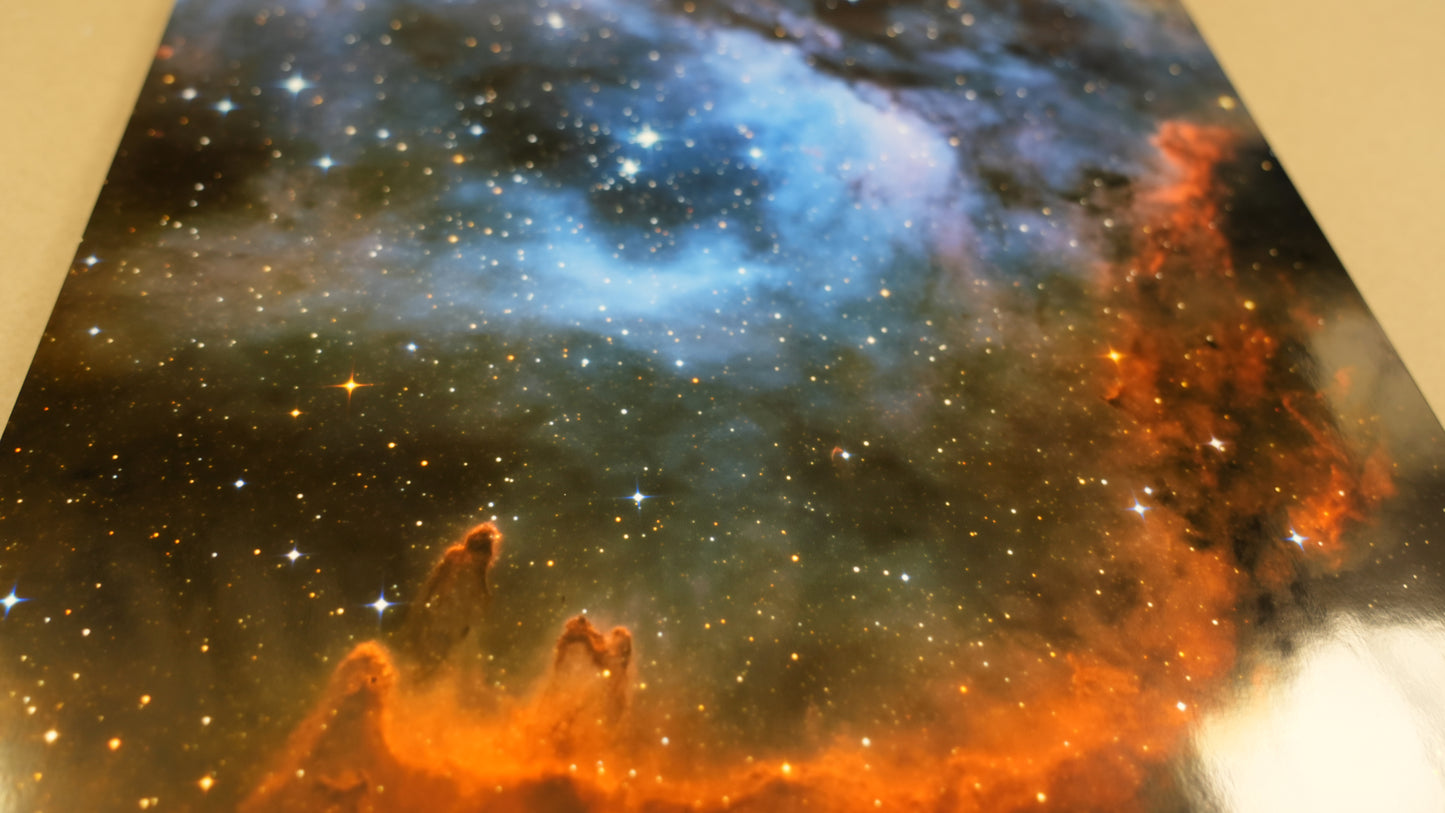 Colorful nebula with orange and blue hues against a black background